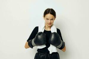 young beautiful woman with towel boxing black gloves posing sports isolated background photo