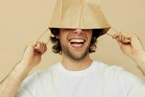 Cheerful man paper grocery bag posing Lifestyle unaltered photo