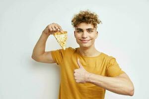 handsome young man eating pizza posing close-up Lifestyle unaltered photo