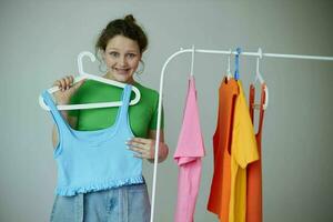 pretty girl trying on clothes wardrobe Youth style light background unaltered photo
