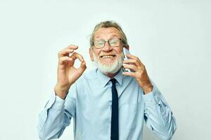 old man in a shirt with a tie talking on the phone cropped view photo