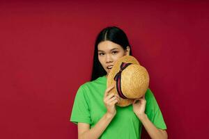 pretty brunette in a green t-shirt gesturing with his hands fun red background unaltered photo