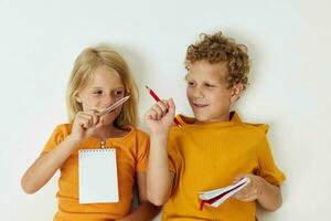 Boy and girl emotions drawing together notepad and pencils isolated background unaltered photo