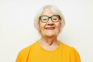 emotional elderly woman in casual t-shirt and glasses close-up photo