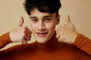 A young man brown turtleneck posing fashion light background unaltered photo