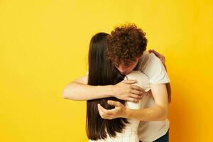 teenagers hug friendship relationship fun yellow background unaltered photo