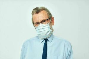 old man in shirt with tie medical mask safety light background photo