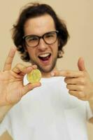 Cheerful man with glasses gold bitcoin in hands Lifestyle unaltered photo