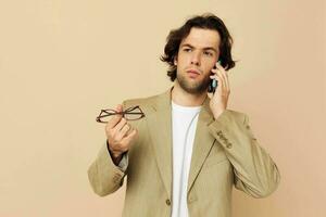 handsome man communication by phone beige suit elegant style isolated background photo