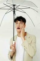 handsome guy transparent umbrella a man in a light jacket isolated background unaltered photo