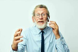 old man with phone in studio on white background talking photo