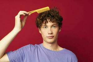 cute red-haired guy comb hair care posing isolated background photo