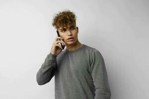 Attractive man talking on the phone posing emotions isolated background photo