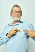 Photo of retired old man finance gold coins bitcoin posing isolated background