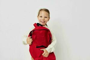 pretty young girl school backpack with a hat on his head childhood unaltered photo