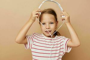 little girl in striped t-shirt headphones gesture hands childhood unaltered photo