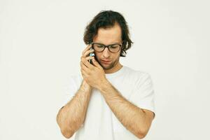 man in a white T-shirt communication by phone Lifestyle unaltered photo