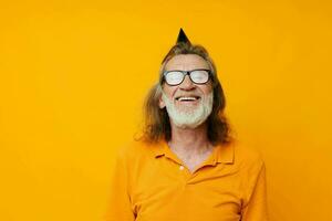 Senior grey-haired man fun birthday cap on the head isolated background photo