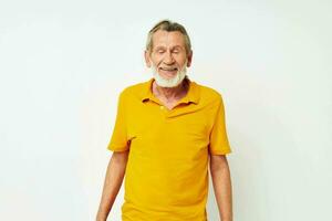 Senior grey-haired man with a gray beard emotion gestures hands light background photo