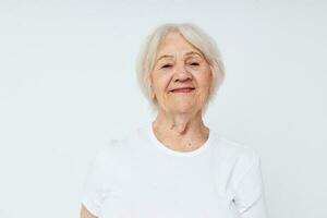 portrait of smiling elderly woman white t-shirt isolated background photo