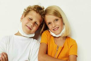 Cute stylish kids fun medical mask stand side by side close-up lifestyle unaltered photo