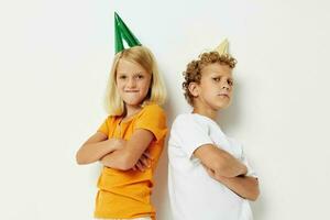 cheerful children in multicolored caps birthday holiday emotion isolated background unaltered photo