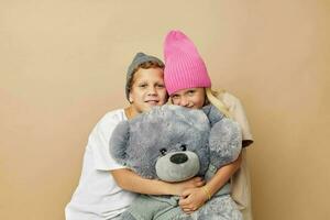 Boy and girl in multi-colored hats entertainment posing isolated background photo