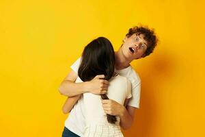 teenagers hug friendship relationship fun yellow background unaltered photo