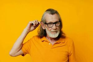 an elderly man in a yellow T-shirt with a comb gray hair photo