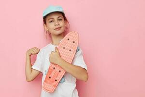 cute girl cap in white t-shirt skateboard isolated background photo