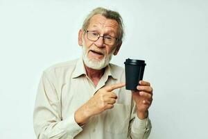 elderly man in a shirt and glasses a black glass light background photo