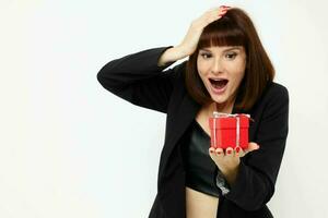 attractive woman with gift small box in a leather suit black jacket Lifestyle unaltered photo