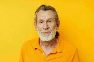 Senior grey-haired man yellow shirt posing emotions isolated background photo