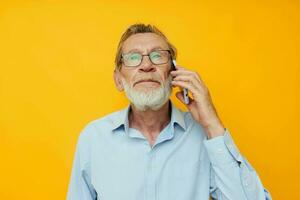 old man gray beard with glasses talking on the phone isolated background photo