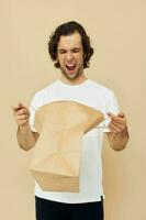 handsome man paper grocery bag posing Lifestyle unaltered photo