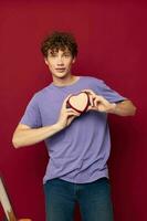 cute guy in purple t-shirt heart-shaped gift holiday photo