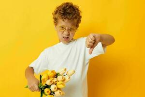 Photo portrait curly little boy with yellow flowers posing childhood fun isolated background unaltered