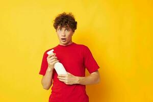 Young curly-haired man detergent posing emotion Lifestyle unaltered photo