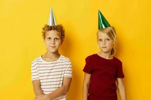 cheerful children holiday fun with caps on your head isolated background photo