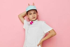 Portrait of happy smiling child girl listening to music on headphones Lifestyle unaltered photo