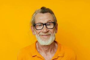 cheerful old man gray beard glasses yellow background photo