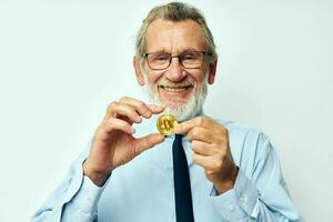 Portrait elderly man Bitcoin cryptocurrency in the hands of a financier isolated background photo
