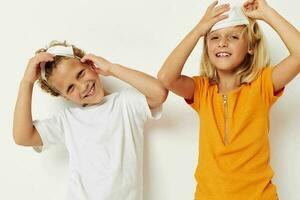 two joyful children fun medical mask stand side by side close-up light background photo