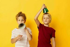 cheerful children holiday fun with caps on your head isolated background photo