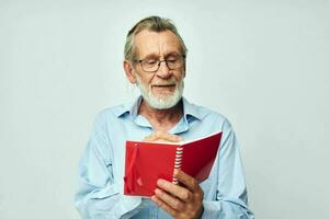 old man writes down emotions in a notebook light background photo