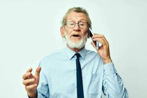 old man with phone in studio on white background talking photo