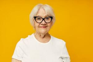 Portrait of an old friendly woman in casual t-shirt and glasses close-up emotions photo