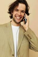 handsome man in a suit posing emotions talking on the phone isolated background photo