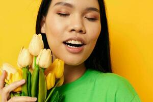 pretty brunette green t-shirt a bouquet of yellow flowers isolated background unaltered photo