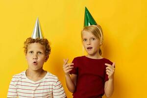 cheerful children holiday fun with caps on your head isolated background photo